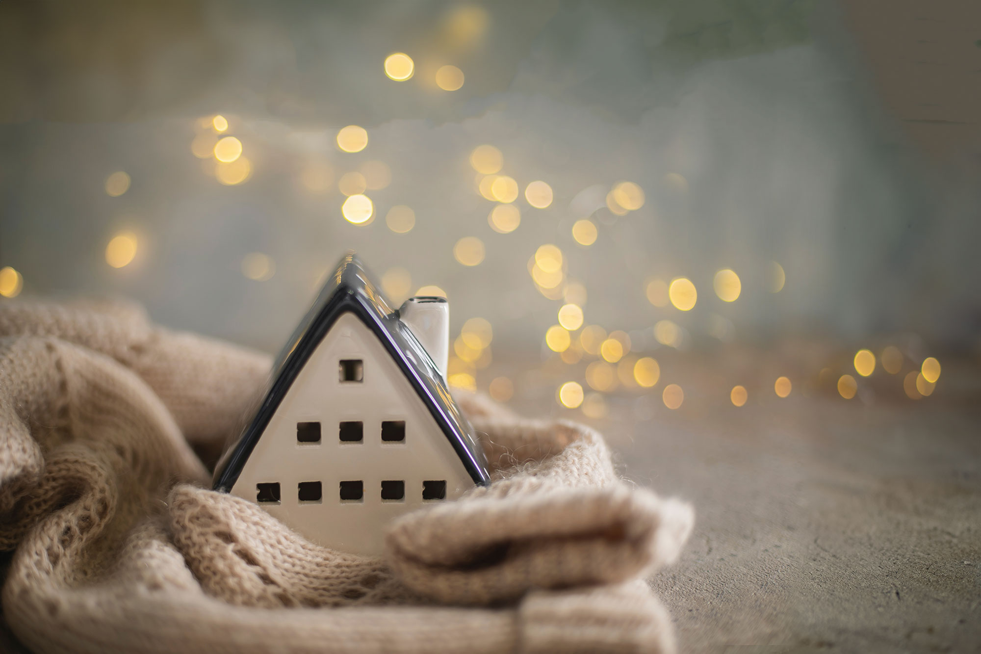 Toy house snuggled i a blanket to show how cozy winter is with Eco-Fuel.